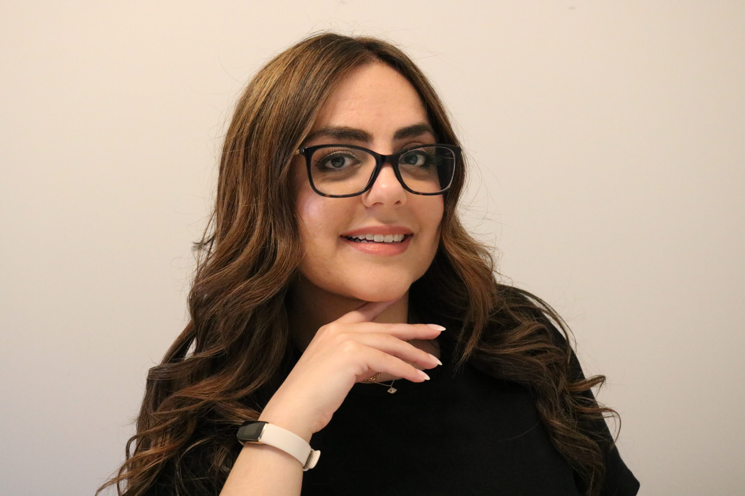 Picture of female sitting with hand under chin