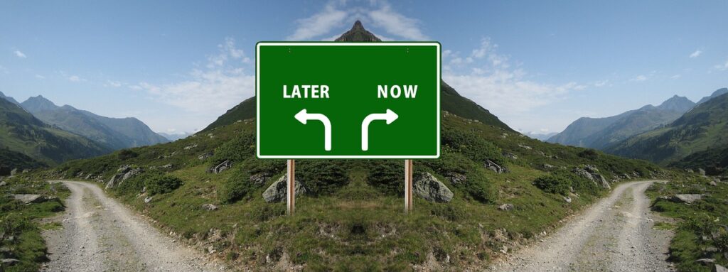 sign that says "later" and "now" with arrows going in separate directions