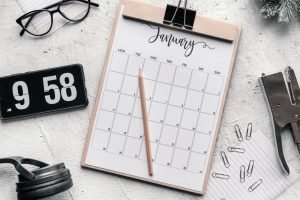 image of calendar on clipboard for January with pencil on top